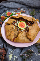 Tasty delicious lean fig tart full of sweet fruits and dry fruits. Backed in oven, made for fasting days. Sweet vegan dessert, vegetarian breakfast. Healthy food. No sugar added. Organic ingredients.