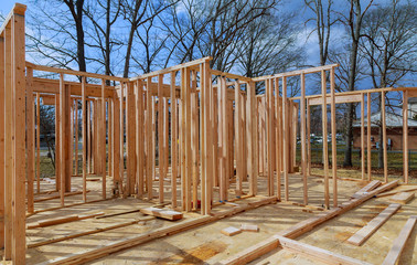 Close-up new stick built home under construction under blue sky Framing structure wood frame of...