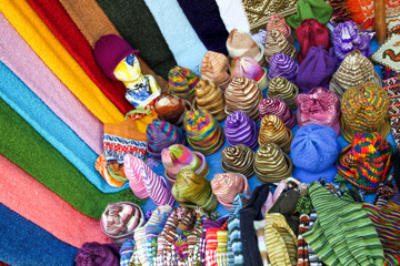 Obraz premium Multicoloured Wool Hats and Scarfs on Mexican Market Stall.