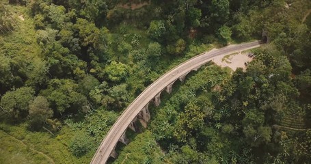 Aerial panoramic top view, drone turning left over Nine Arch Bridge Ella in Sri Lanka among exotic lush green trees.