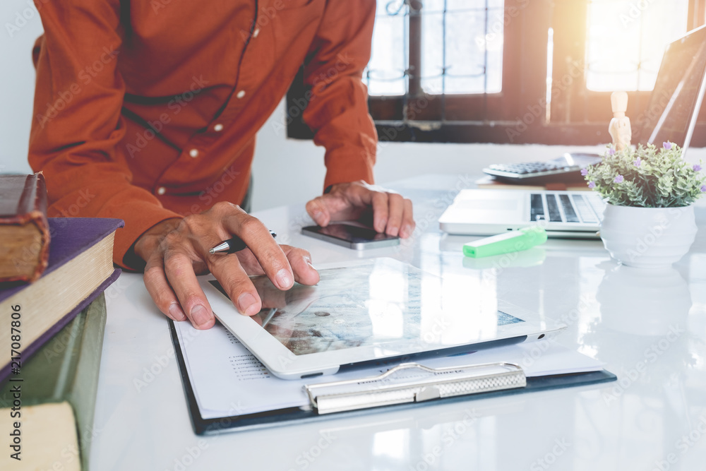 Poster business man hands using digital tablet and smart phone on white desk table with laptop computer,boo