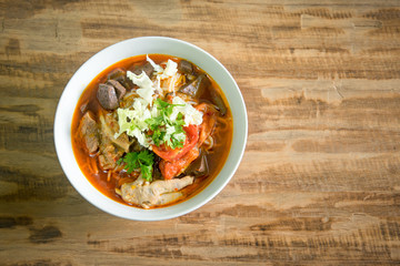 Thai food in northern style, Kanom Jeen Nam Ngiew most famous of  thai northern, on wood background with space for text