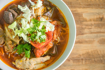 Thai food in northern style, Kanom Jeen Nam Ngiew most famous of  thai northern, on wood background with space for text