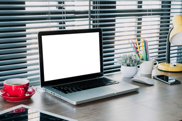 Mock up laptop, office supplies on stylish minimal desk.Laptop computer with blank screen for product display.
