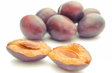 Fresh ripe plums on white background, healthy fruits