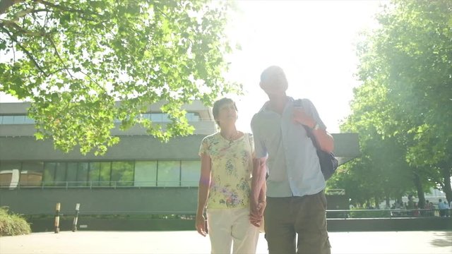 Slow Motion Steady Cam View Of An Active Senior Caucasian Tourist Couple Walking In London Backlit By The Sun Themes Of Sightseeing Active Seniors Direction On The Move