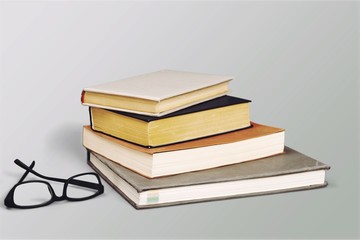 Colorful books collection on background.