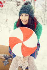 brunette girl in a green hat and in a costume of flowers traditional to the elves Santa's helpers...