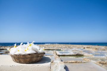 Gozo Island Natural Sea Salt basket with Salines and Blue Sea in the Background.