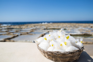 Gozo Island Natural Sea Salt basket with Salines and Blue Sea in the Background.