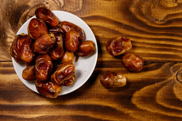 Dried dates fruit on wooden table. Top view