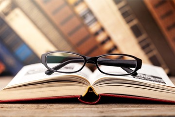 Books and glasses on  table  background,close up