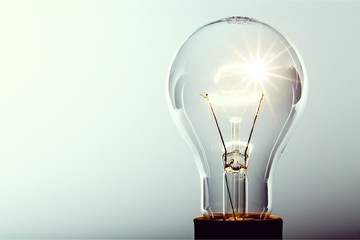 Glowing yellow light bulb, busienss idea concept
