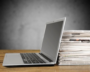 Laptop and black glasses  on   background.