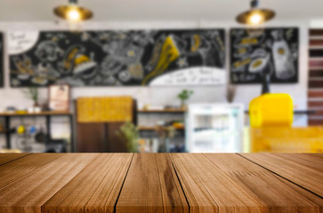 Selected focus empty brown wooden table and Coffee shop or restaurant blur background with bokeh image. for your photomontage or product display