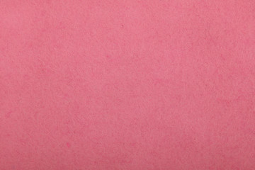 Pink felt background texture close up