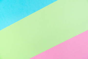 Pastel colored paper flat lay top view, background texture, pink, purple, yellow, beige, green and blue.