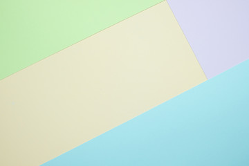 Fashionable  pastel colored paper flat lay top view, geometric background texture, pink, purple, yellow, beige, green and blue.