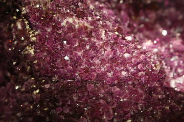 Close up background of purple amethyst crystals