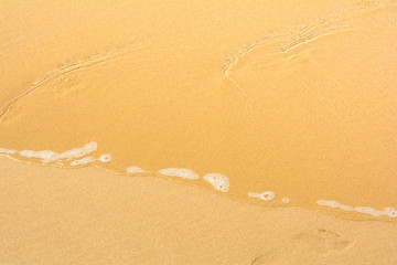 Soft ocean wave with foam on the sandy beach sunny day in summer background in Gold Coast, Queensland, Australia