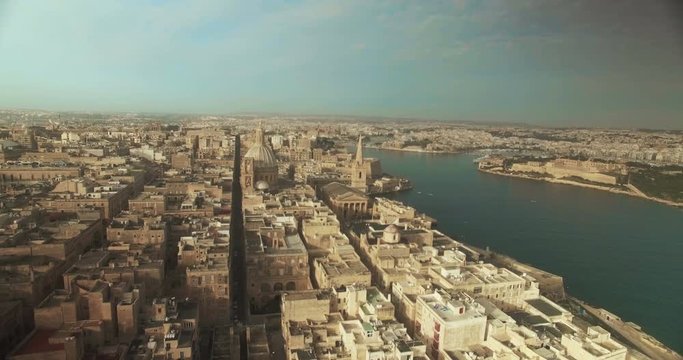 Aerial Shot - Flying backwards over a City by the City
