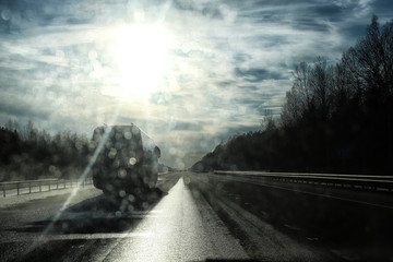 Road and glare from the sun on the car windshield