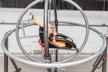 Woman having fun at the astronaut training gyroscope swing