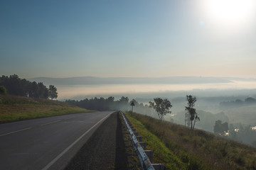 picturesque view of highway on hill with mountains on background
