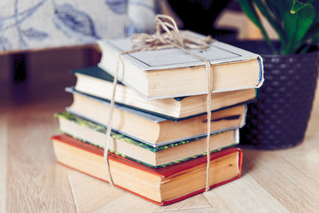 a pile of books tied with a rope