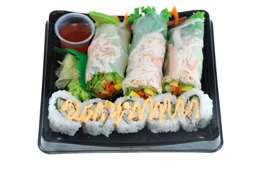 close up on fresh spring roll and sushi on black tray