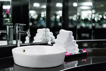 Interior of bathroom with washbasin faucet and white towel in hotel. Modern design of bathroom..