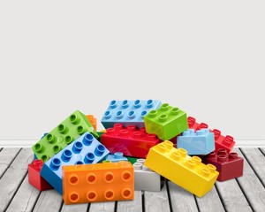 Colorful children building bricks on desk