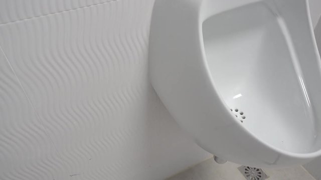 Urinal in Men's Public Toilet, Dolly shot.