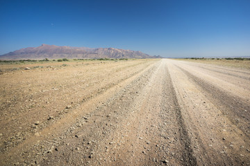Fototapeta na wymiar Gravelroad at the african namibian landscape