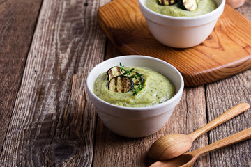 Healthy zucchini cream soup in ceramic bowls