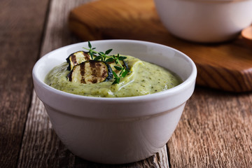 Healthy zucchini cream soup in ceramic bowls