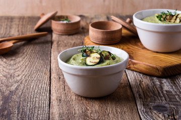 Healthy zucchini cream soup in ceramic bowls