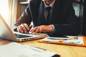 business documents on office desk with laptop and smart phone and graph business diagram and man...