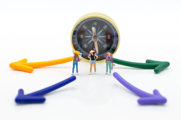 Miniature people : Traveler stand front the compass to tell the direction of travel. Image use for business travel concept.