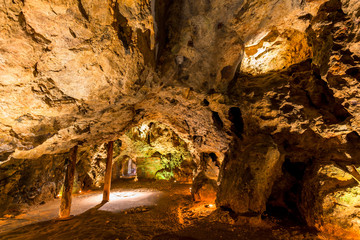 an empty picturesque cave illuminated by flashlights Krakow, Dragon Cave