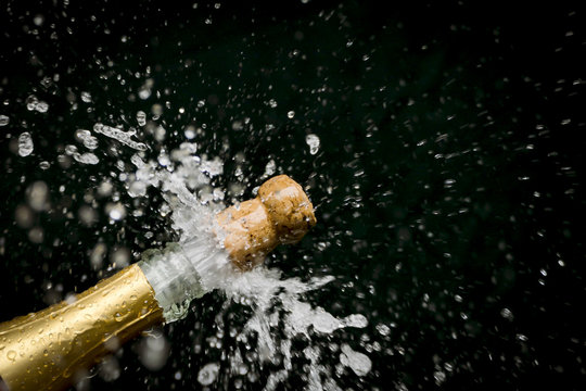 a champagne cork is popping out