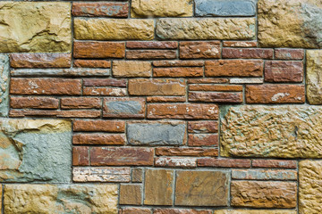 background - beige and red stone facade decoration close-up