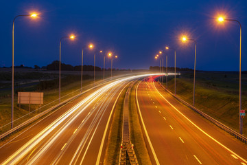 Fototapeta na wymiar Traces of lights on the night highway