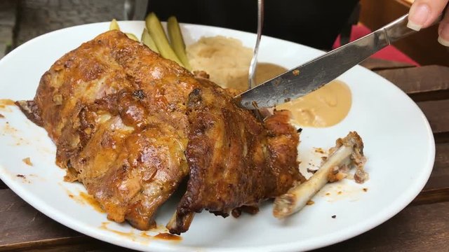 Girl eating beautiful pork ribs, Prague, Czech Republic