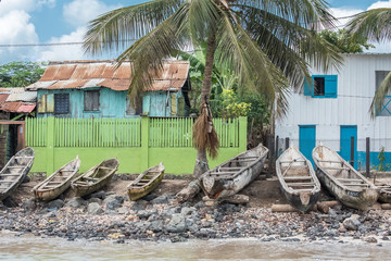 Sao Tome, dugouts on the beach in fishermen's village, typical houses
