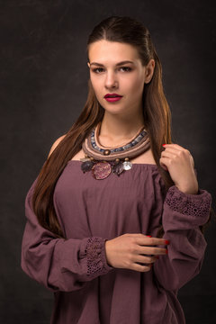 Beautiful female brunette model in handmade accessories fashion jewelry necklace. Fashion photo.