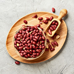 Bowl of fried peanut and scoop. Top view..