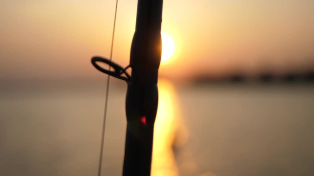Fishing rod playing with the sunset on a lake in the Netherlands. Shot in 4K on a GH5