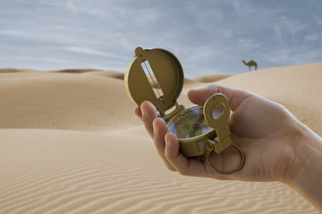 compass in hand and desert background