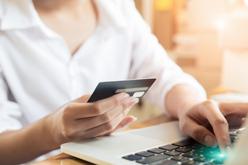 Young asian women hands holding credit card for online shopping at home,teenager owner business,success and online shopping concept.